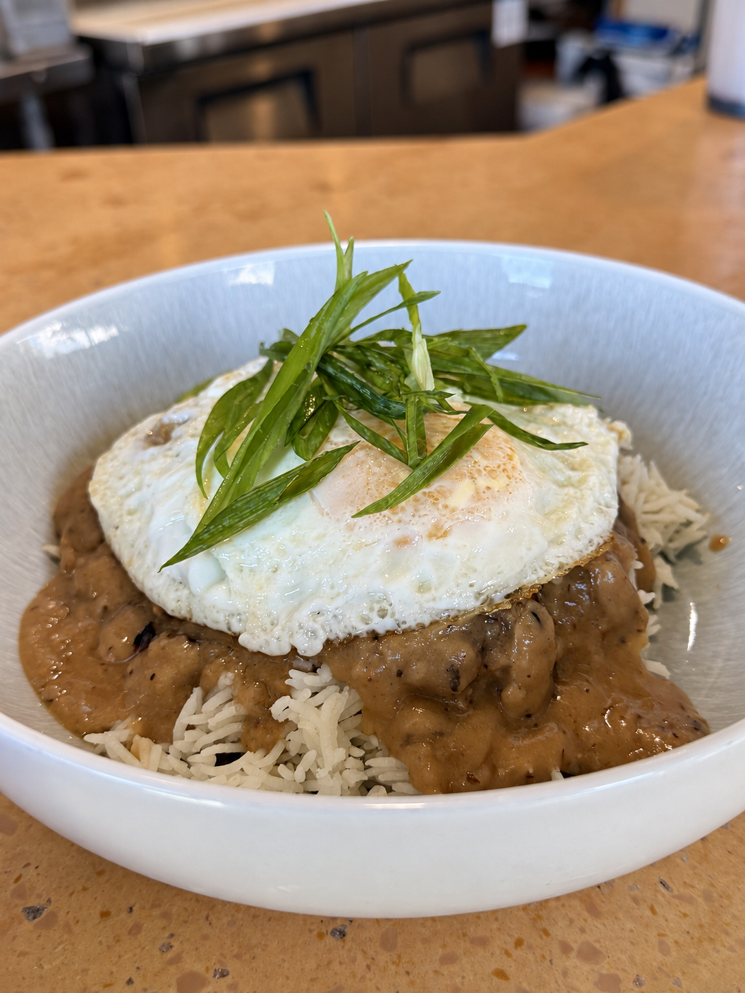 Loco Maui Moco with rice, Maui onion and mushroom gravy, fried eggs, and scallions