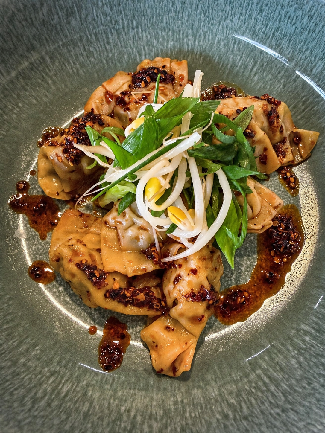 Steamed Chicken Dumplings with Szechuan chili crisp and scallions